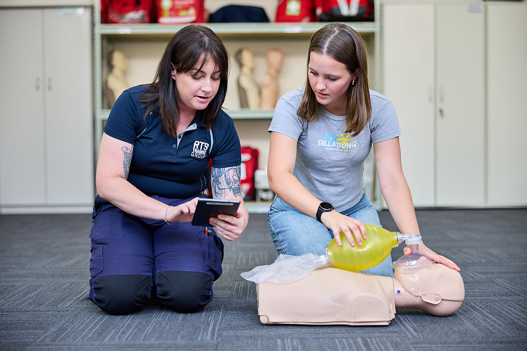 RTS Training trainer coaching a student on CPR in the training room